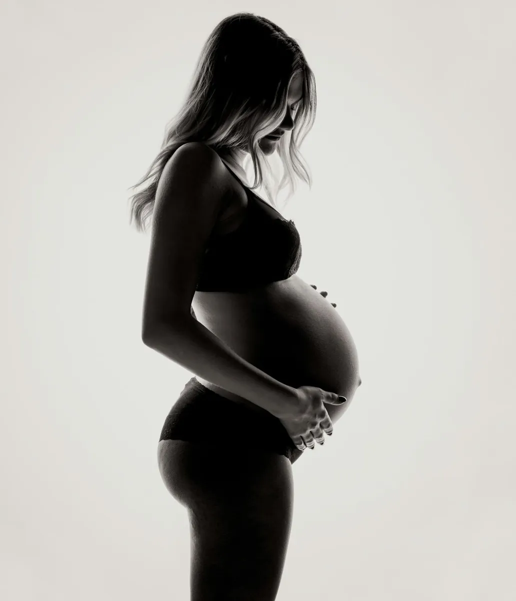 Expecting mother cradling her belly